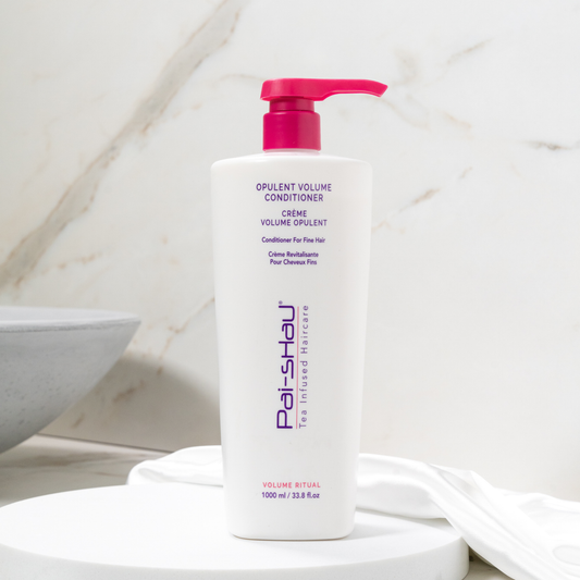 Pai-Shau - Opulent Volume Conditioner — new-livery white 1 L pump bottle on a bathroom counter
