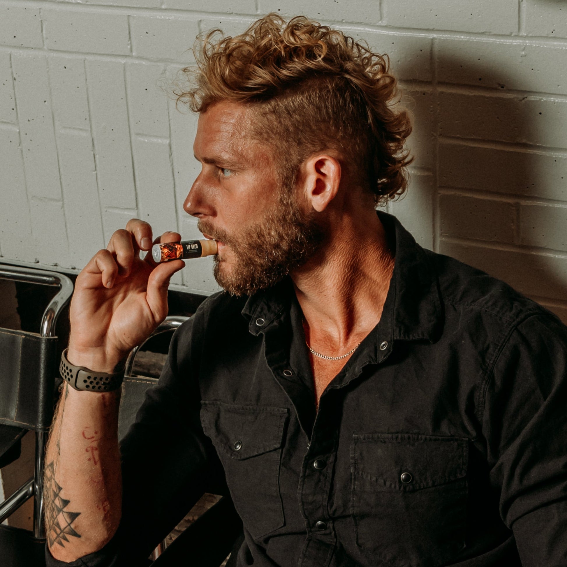18.21 Man Made Lip Balm — lip balm in use, lifestyle shot