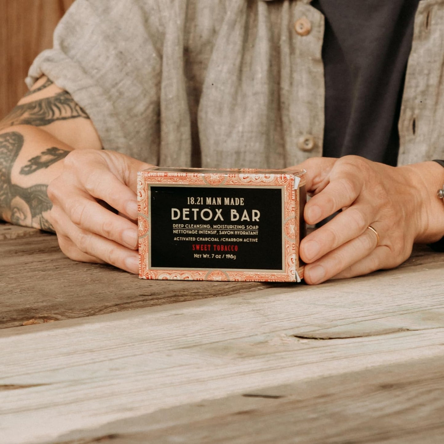 18.21 Man Made Detox Bar — detox bar boxed, held in hands, lifestyle shot