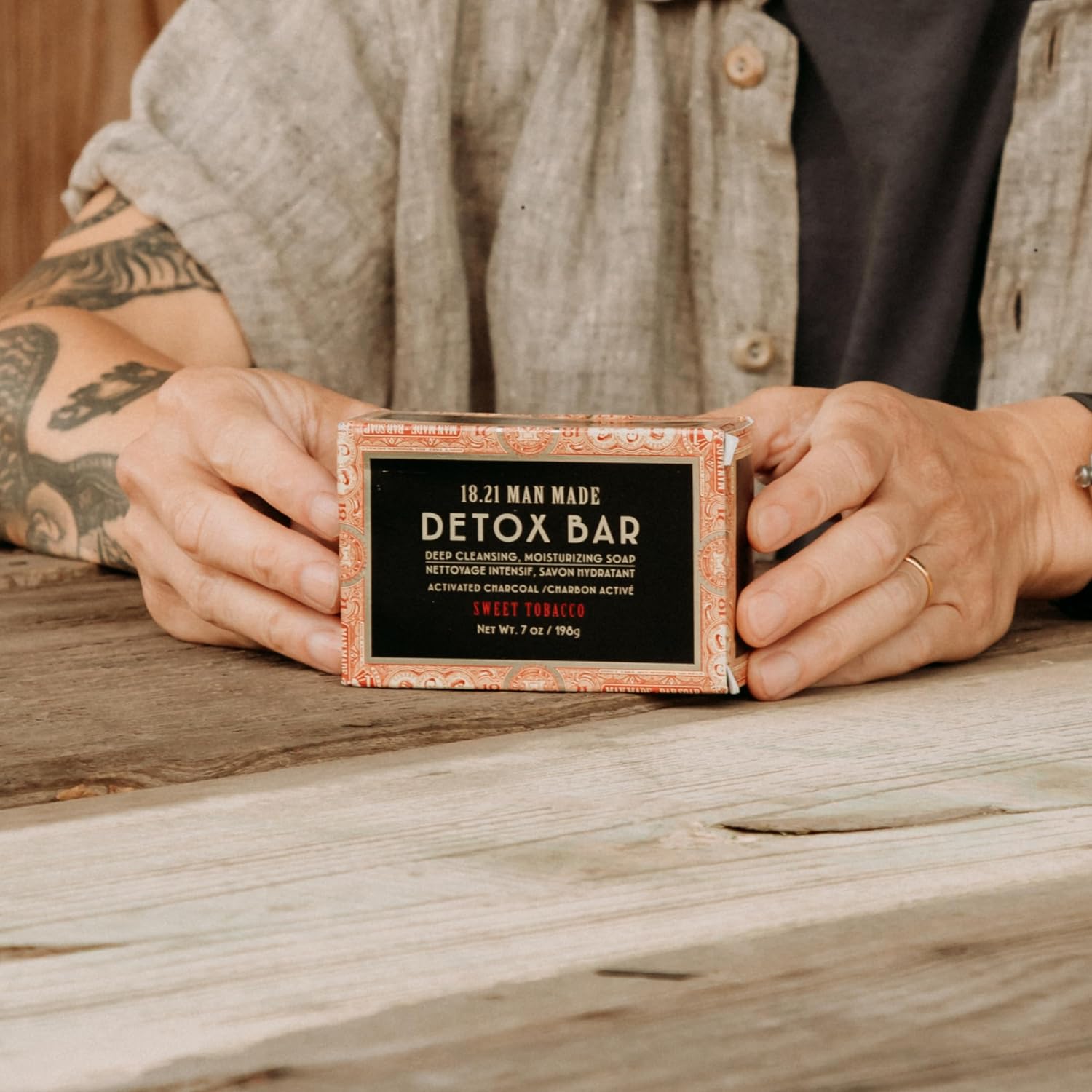 18.21 Man Made Detox Bar — detox bar boxed, held in hands, lifestyle shot