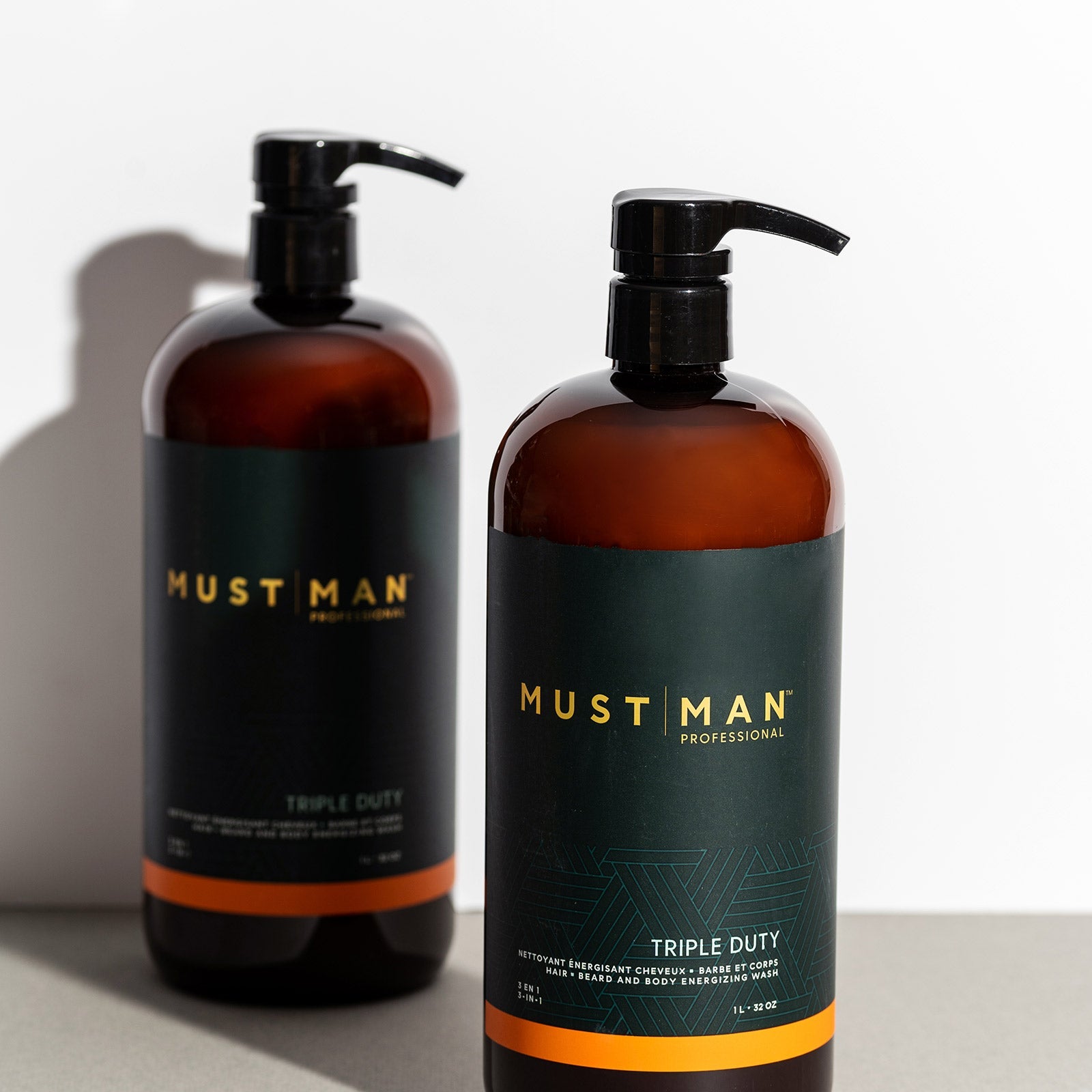 Must Man Professional Triple Duty Hair, Beard & Body Wash — 1 L amber pump bottle beside the 250 ml bottle, size comparison
