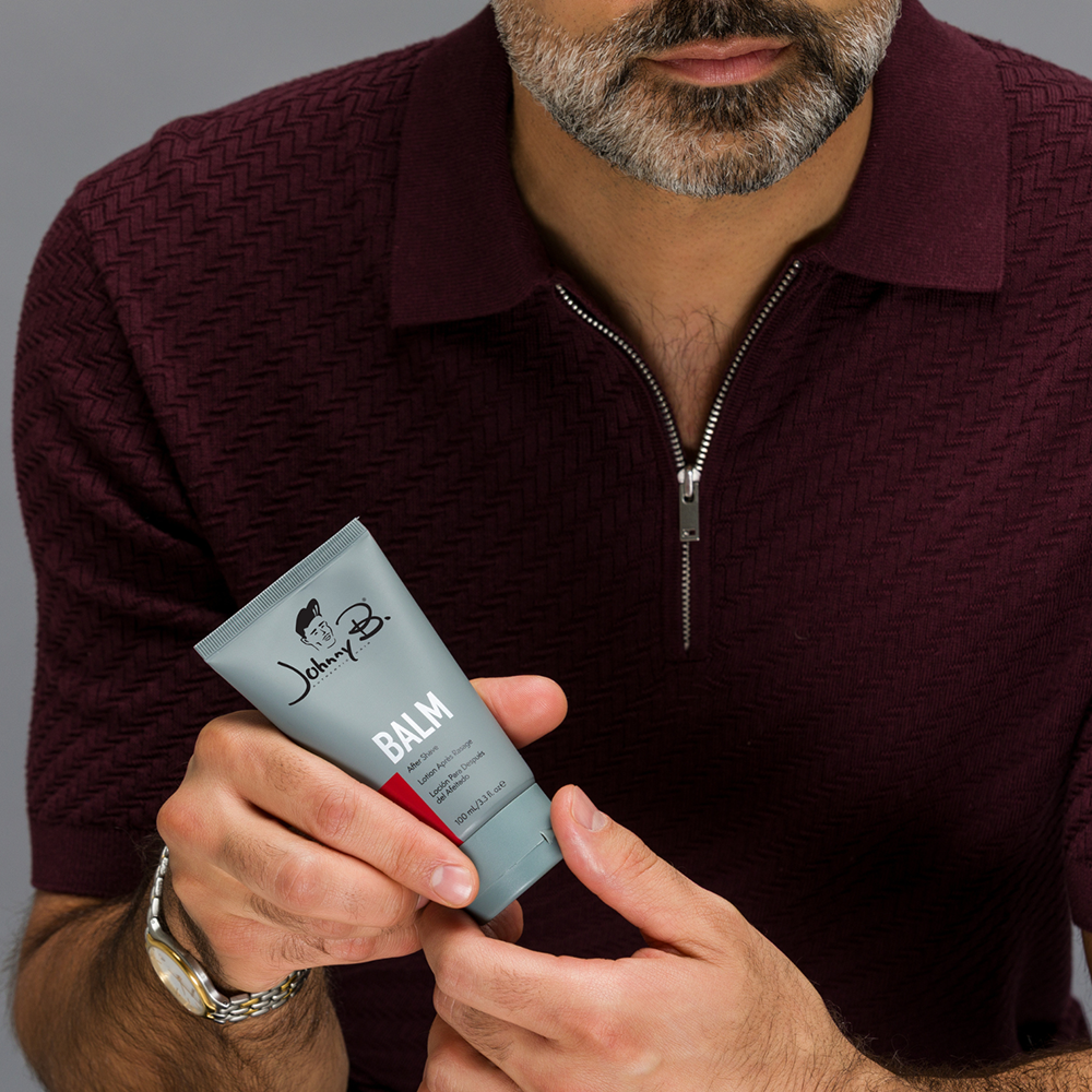 Johnny B After Shave Balm — model holding the 100 ml tube