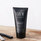 American Crew Moisturizing Shave Cream tube on a barber's counter