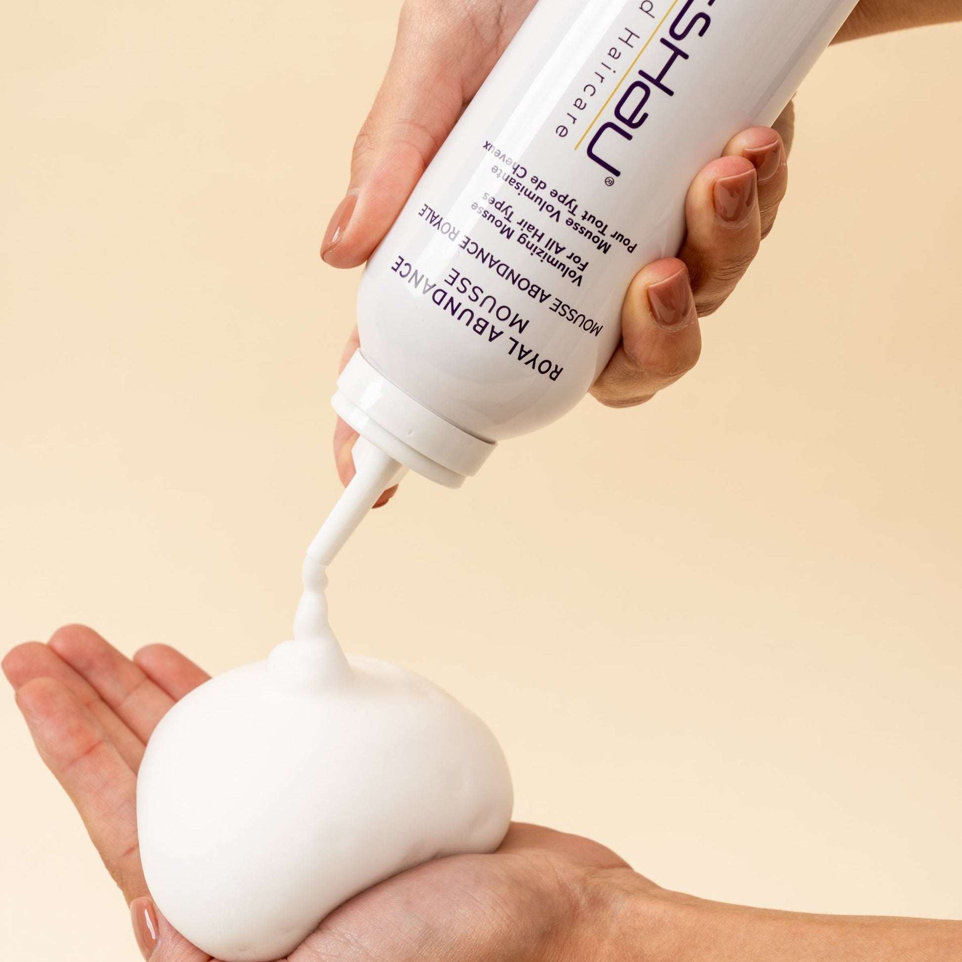 Pai-Shau Volumizing Mousse — mousse dispensed into a cupped hand, showing the foam texture