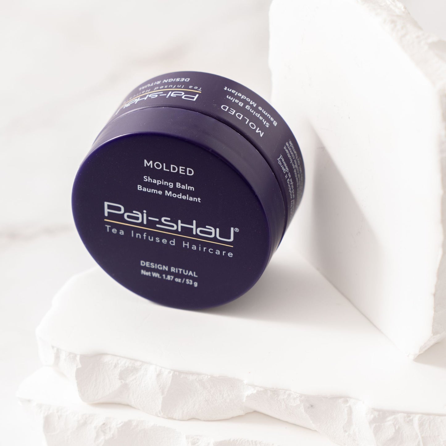 Pai-Shau Shaping Balm — Molded shaping balm jar, lid off, label in close-up
