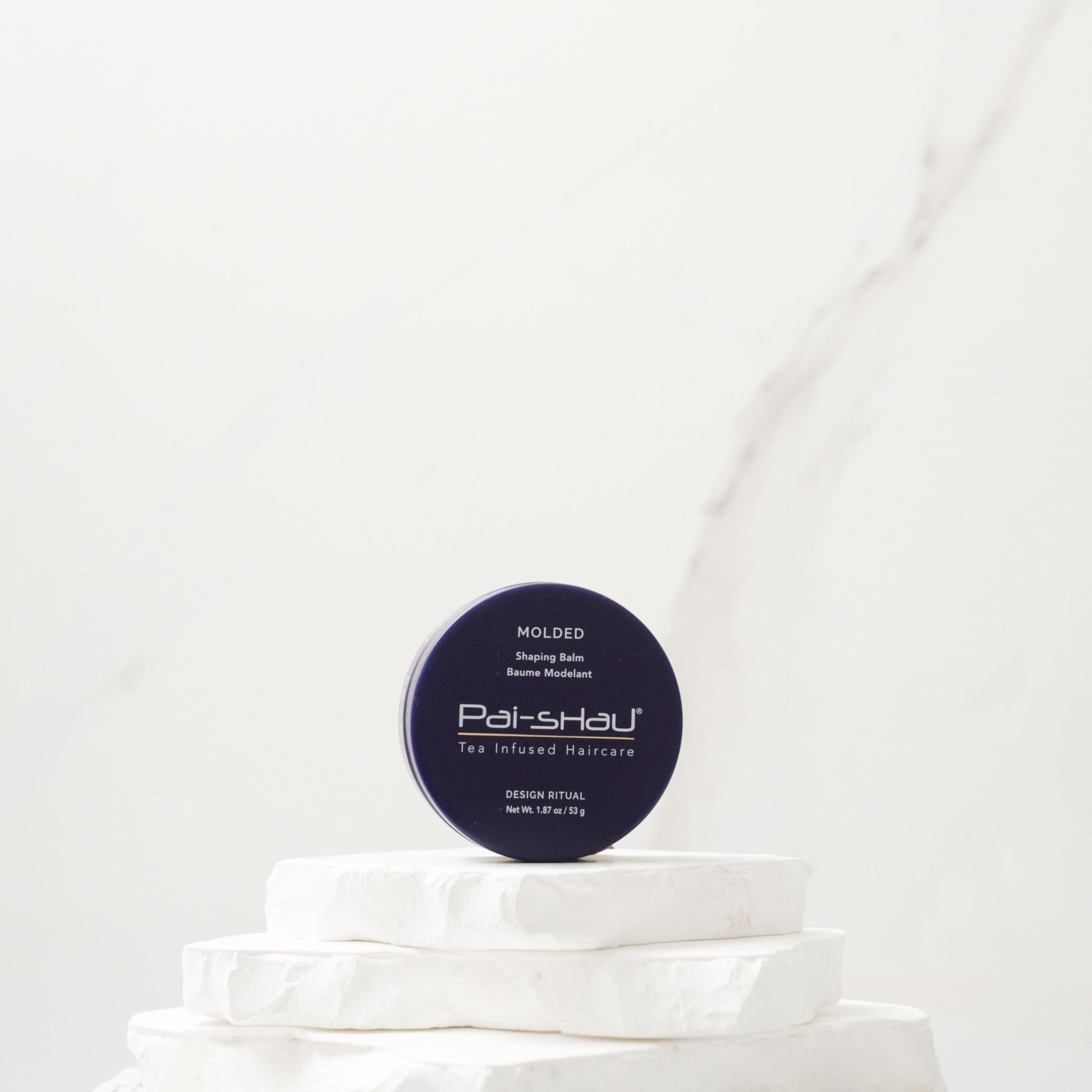 Pai-Shau Shaping Balm — Molded shaping balm jar on a white plinth