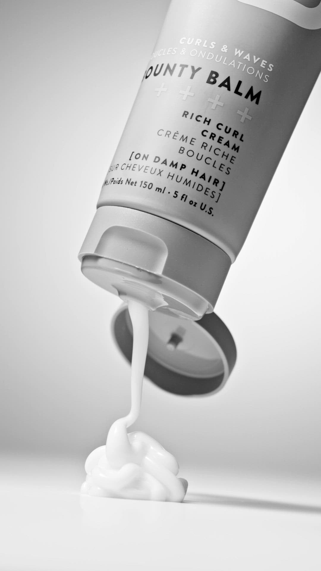 OSiS+ Bounty Balm Rich Curl Cream — grey 150 ml tube pouring rich curl cream, product texture shot