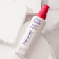 Pai-Shau - Opulent Volume Spray — new-livery white 120 ml spray bottle lying on marble