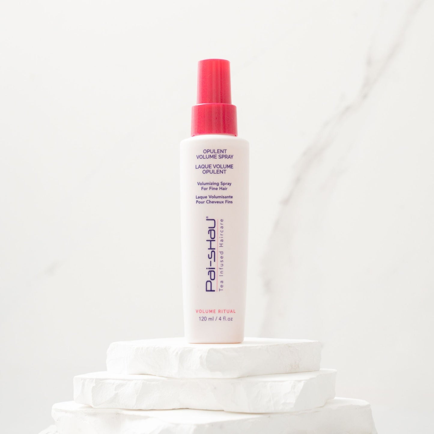 Pai-Shau - Opulent Volume Spray — new-livery white 120 ml spray bottle on a stone plinth