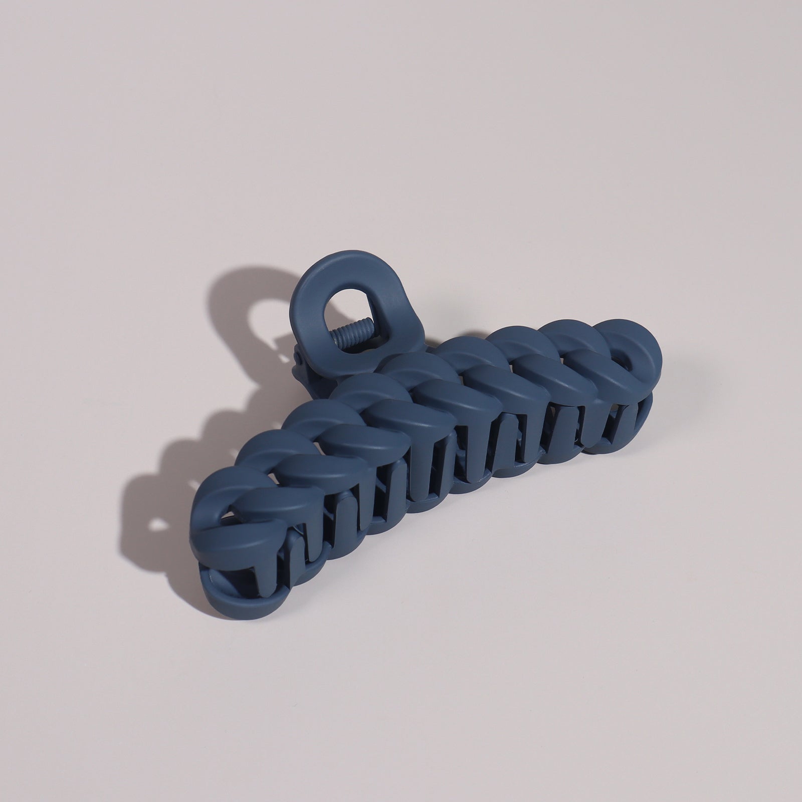 Plug By Must52 Braided Claw Clip — Navy braided claw clip photographed on a soft lilac surface