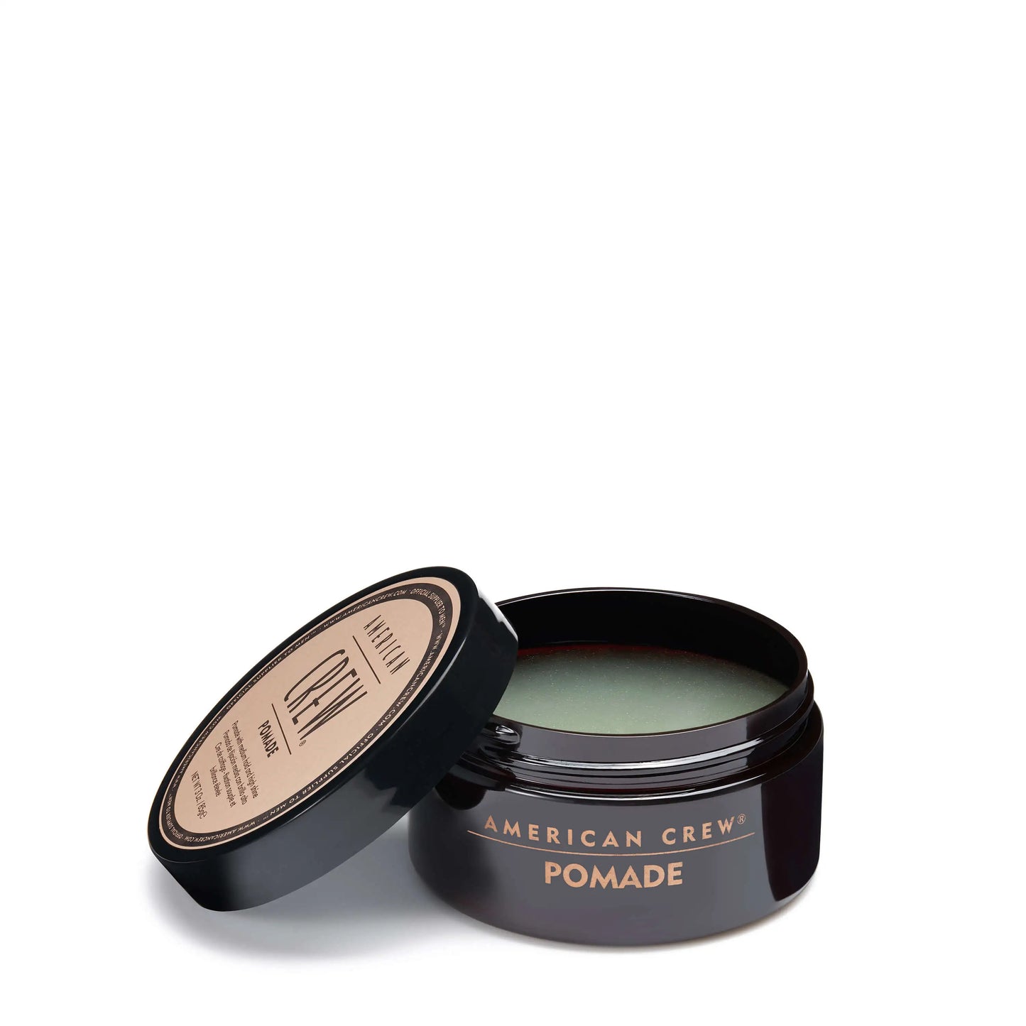 American Crew Pomade — open 85 g tub with the lid resting beside it, lid reading NET WT 3 Oz. / 85g, showing the glossy pomade
