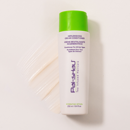 Pai-Shau - Replenishing Cream Conditioner — new-livery white 250 ml bottle lying flat beside a cream swatch