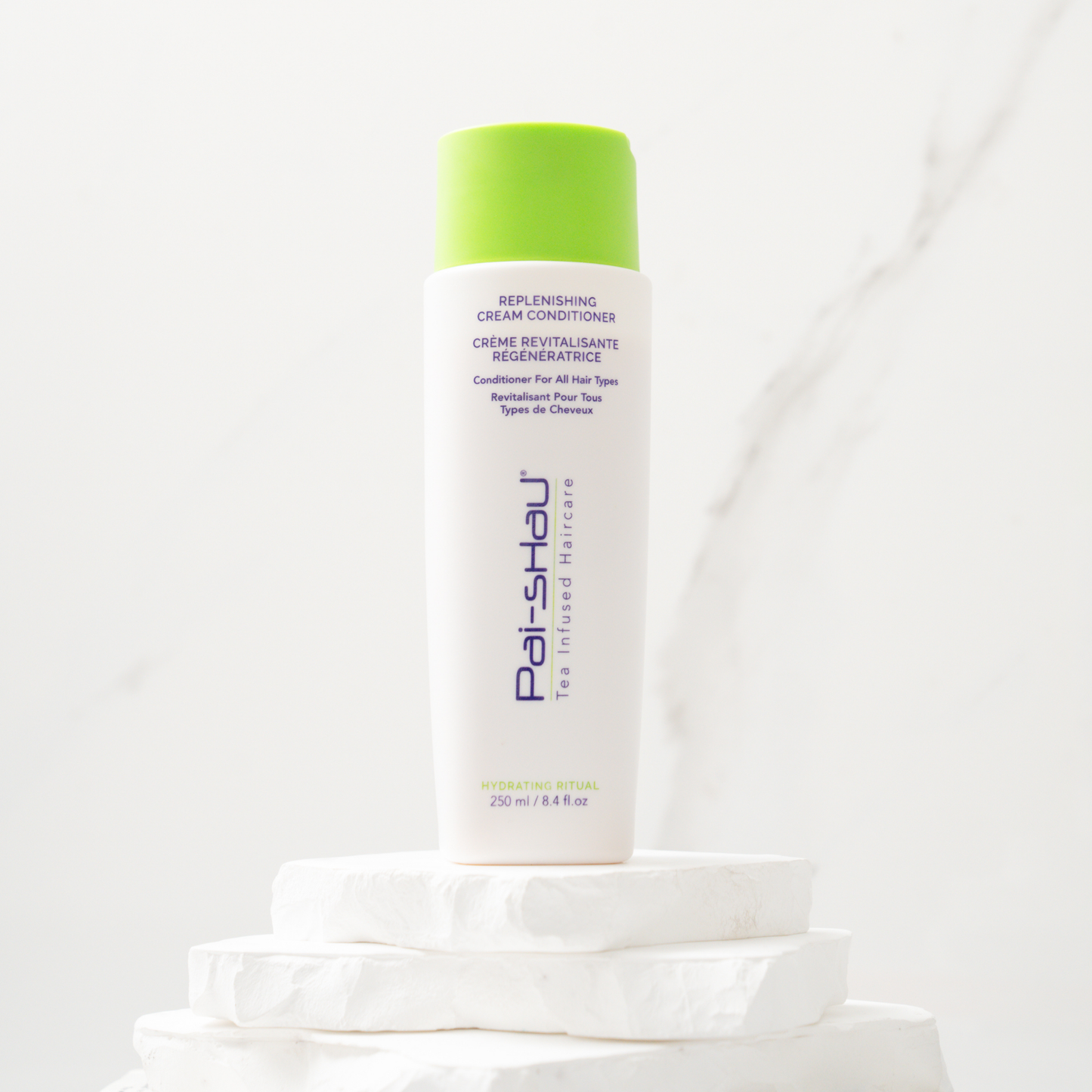 Pai-Shau - Replenishing Cream Conditioner — new-livery white 250 ml bottle on a stone plinth
