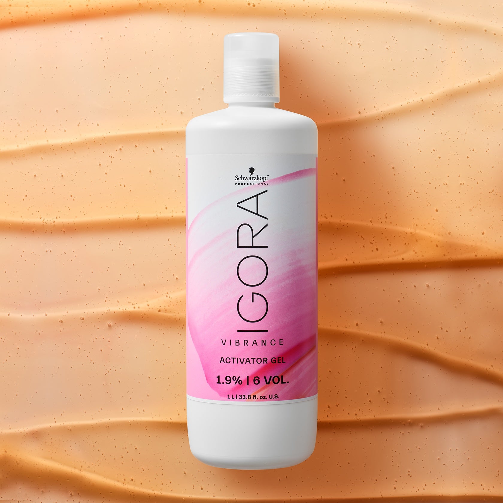 Schwarzkopf IGORA Vibrance Activator Gel — activator gel bottle laid on a swept colour texture