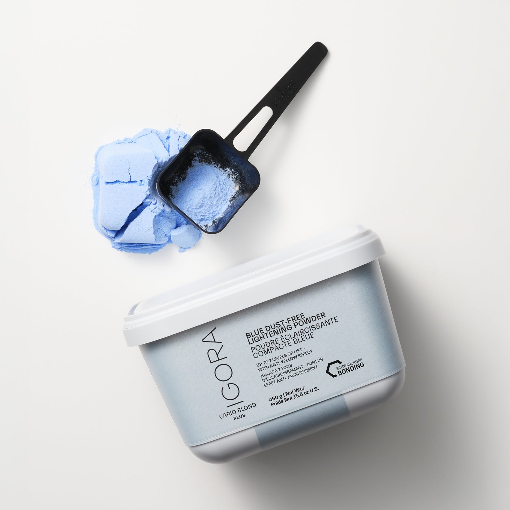 Schwarzkopf IGORA Vario Blond Plus Blue Bleach Dust Free Lightening Powder — tub open beside a bowl of mixed blue lightening powder