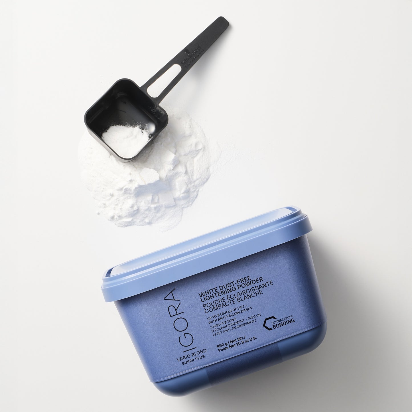 Schwarzkopf IGORA Vario Blond Super Plus — blue tub open beside a scoop of white lightening powder
