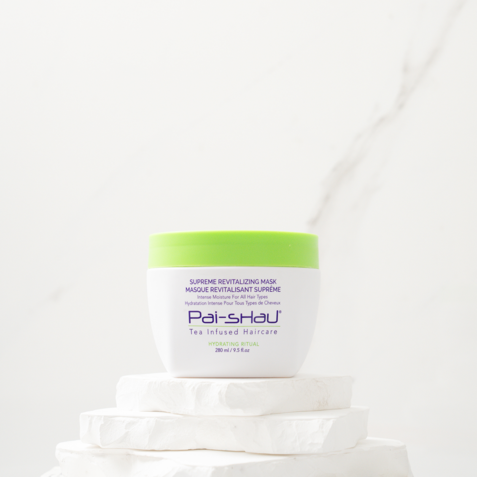 Pai-Shau - Supreme Revitalizing Mask — new-livery white 280 ml jar on a stone plinth against marble