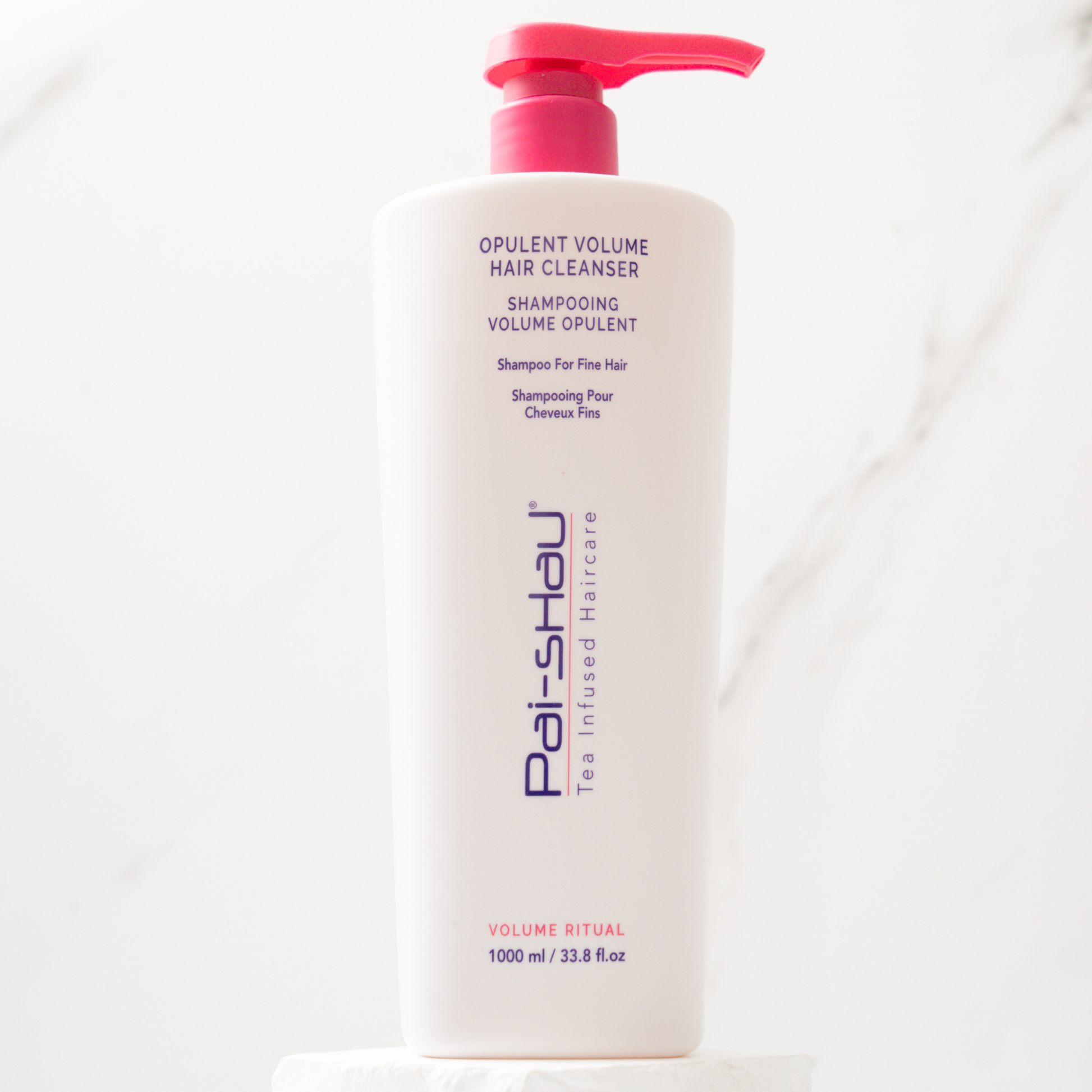 Pai-Shau Volumizing Shampoo — new-livery white 1 L pump bottle on marble