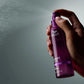 Wella Professionals Ultimate Color — Image of model spraying the Ultimate Color shine spray. Text overlay reads "Mist to add shine and smoothness".