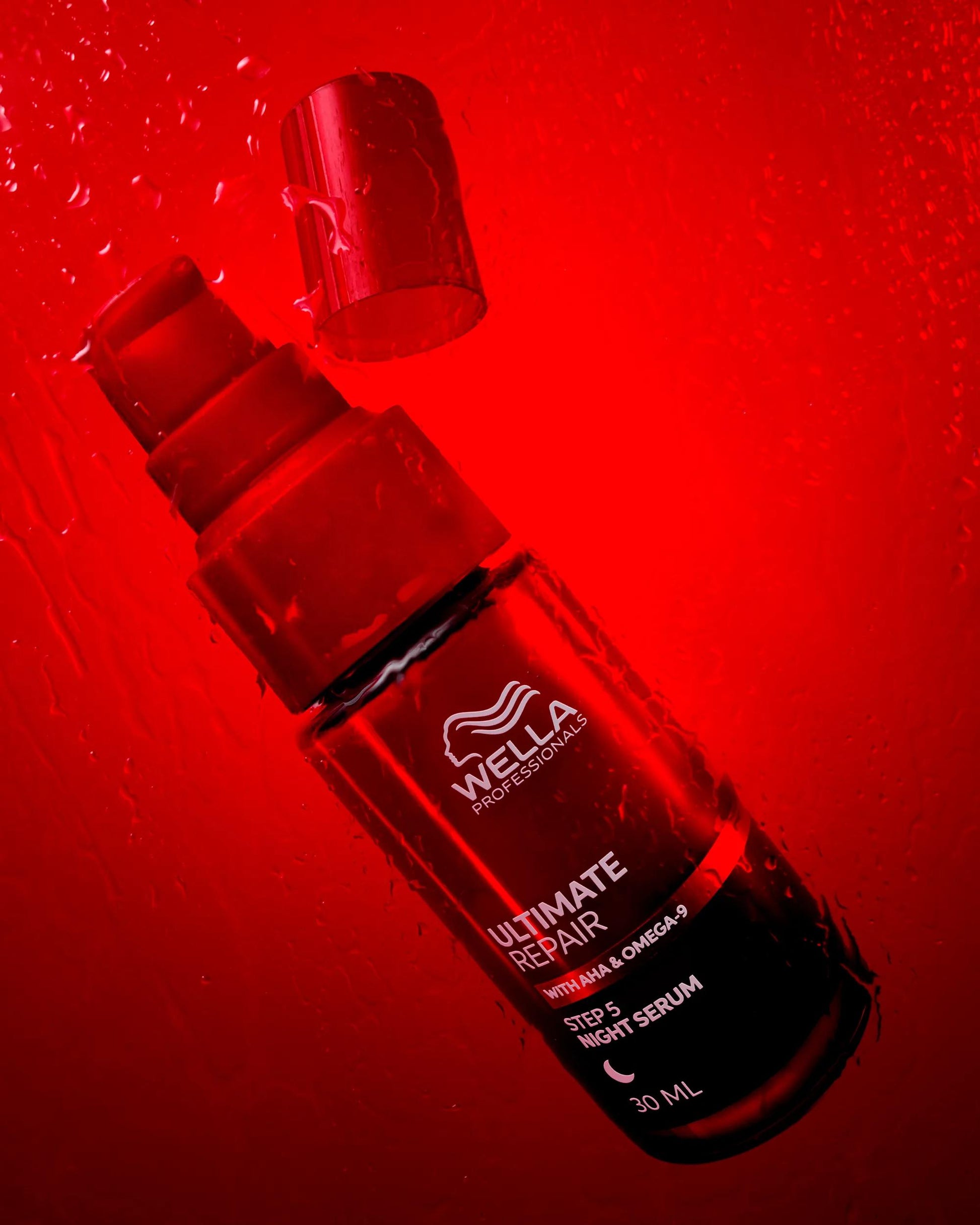 Wella Professionals Ultimate Repair — Image of Wella Ultimate Repair Night Serum over a red background