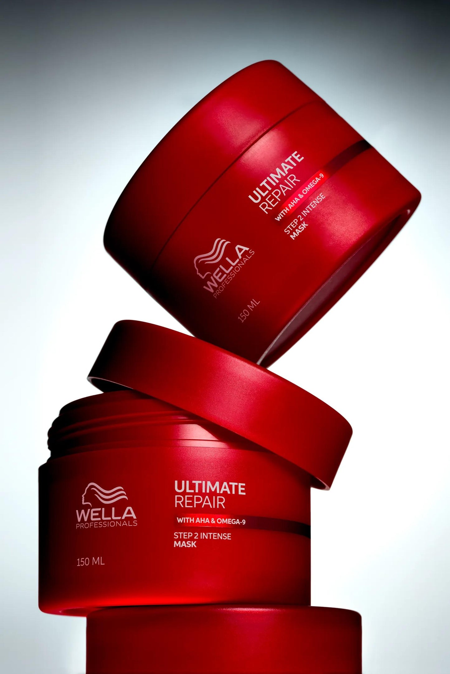 Wella Professionals Ultimate Repair — stacked mask jars on a lit background