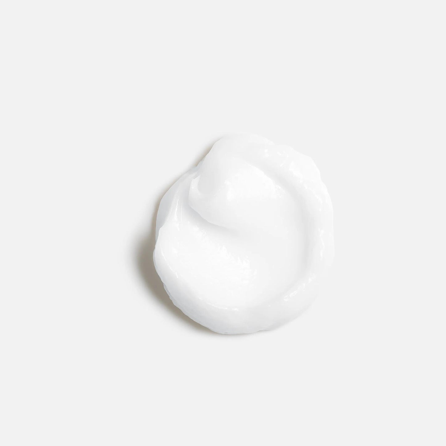 Wella Professionals NutriCurls — A dollop of smooth white cream on a white background.