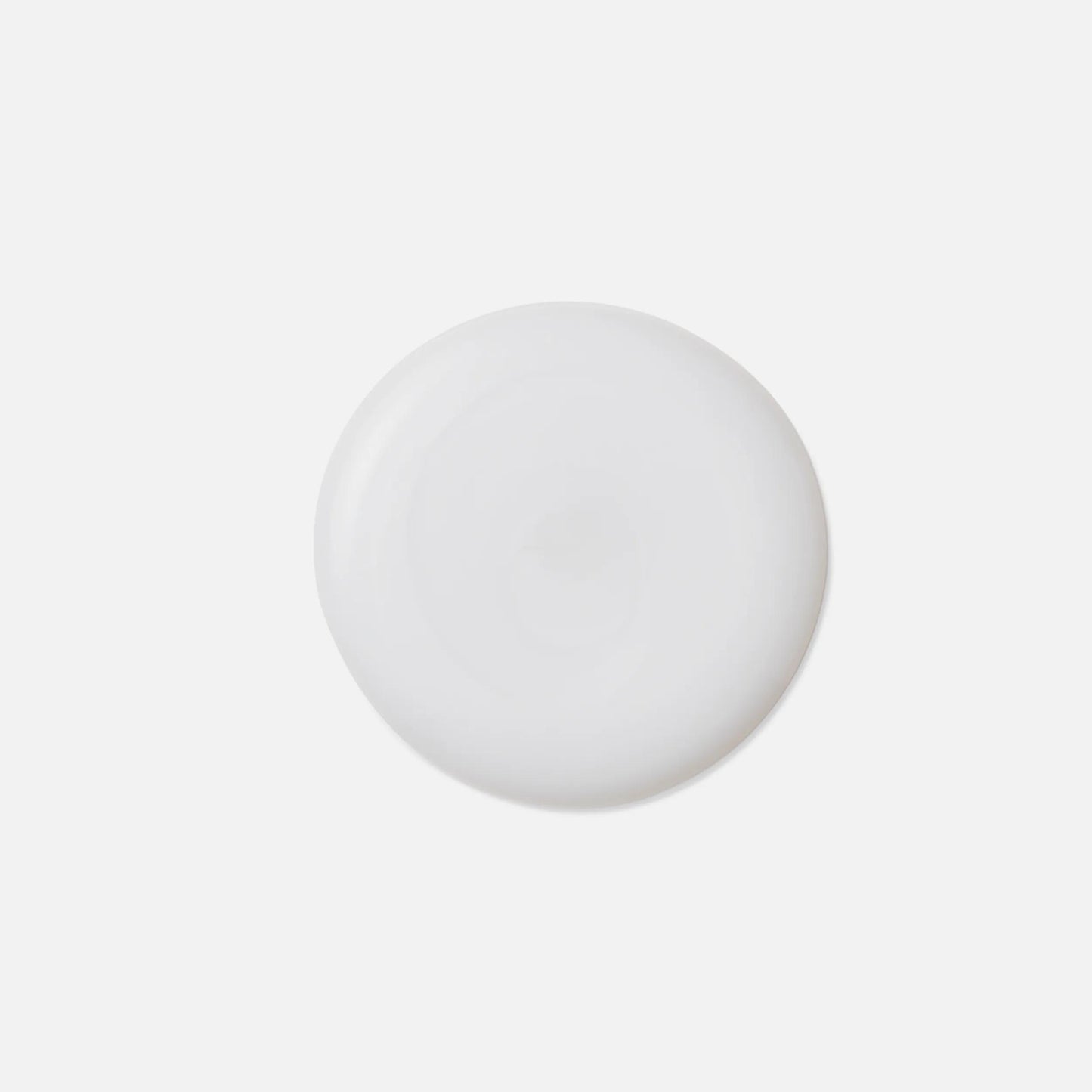 Wella Professionals NutriCurls — A smooth, round drop of white liquid.