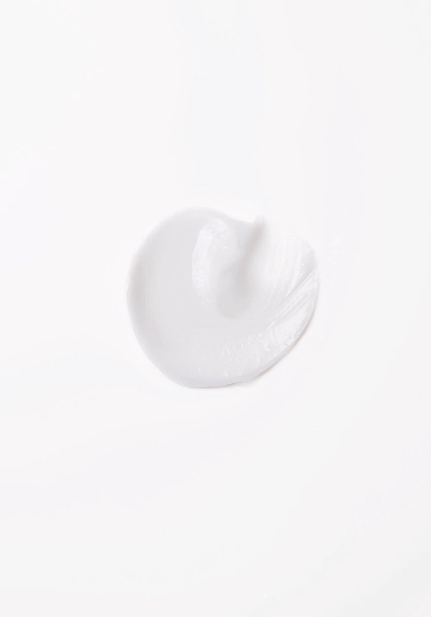 Wella Professionals Invigo Brilliance — Close-up photograph of a circular blob of Invigo Brilliance product on a white background, with text saying 'antioxidant shield, helps control the oxidation process after coloring' and 'metal purifier, protects from harmful metals in water'.
