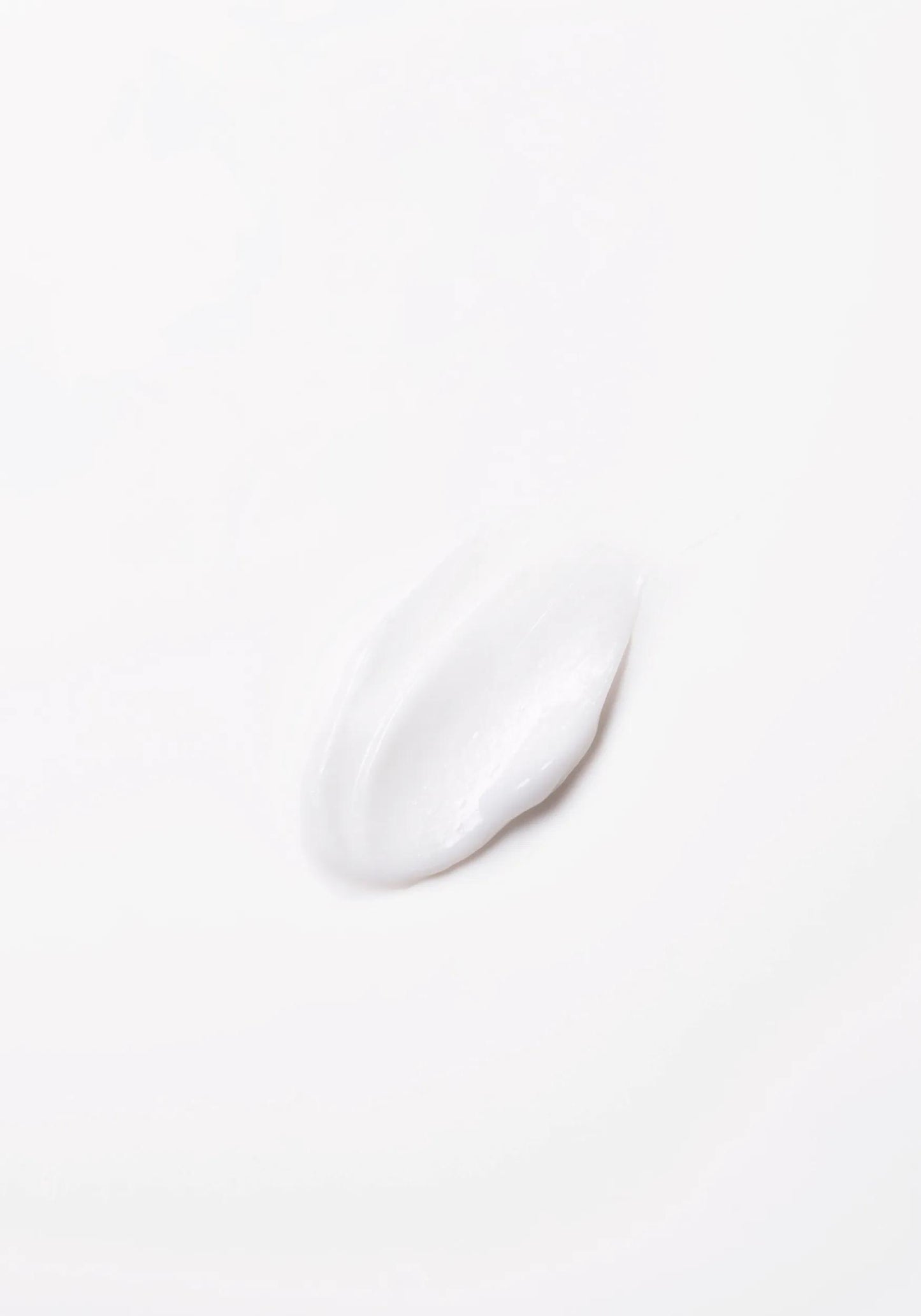 Wella Professionals Invigo Brilliance — Close-up photograph of a circular blob of Invigo Brilliance product on a white background, with text saying 'antioxidant shield, helps control the oxidation process after coloring' and 'metal purifier, protects from harmful metals in water'.