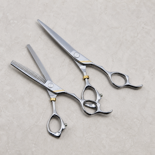 Otto 6-inch Haircutting & Thinning Shear Set — both shears laid out together on a light stone salon surface