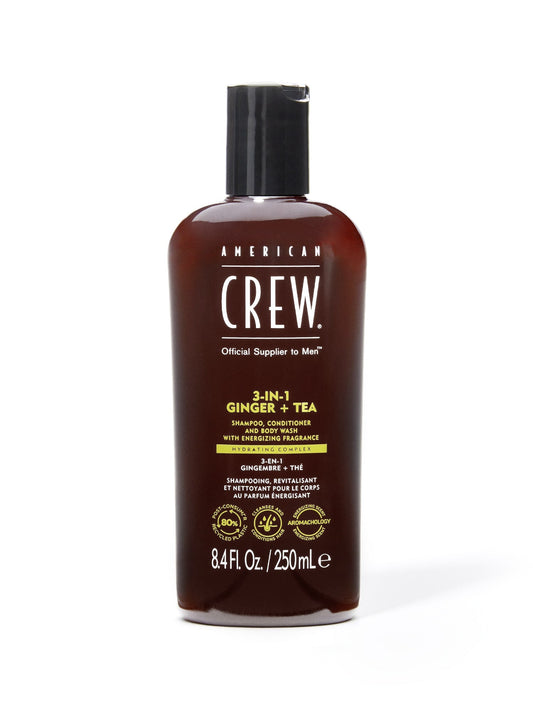 American Crew 3-in-1 Ginger + Tea bottle on a wet tiled surface