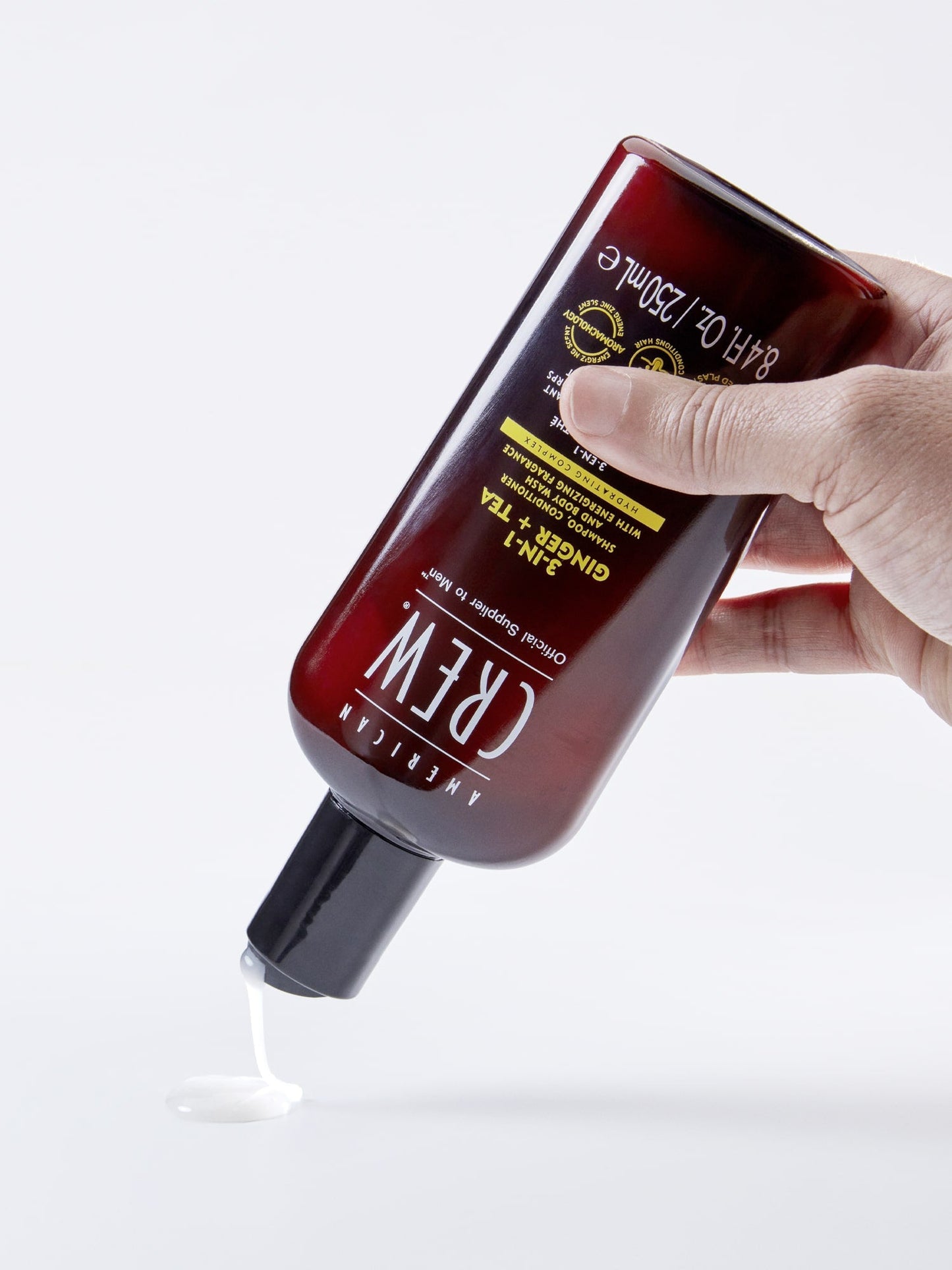 American Crew 3-in-1 Ginger + Tea poured into a hand