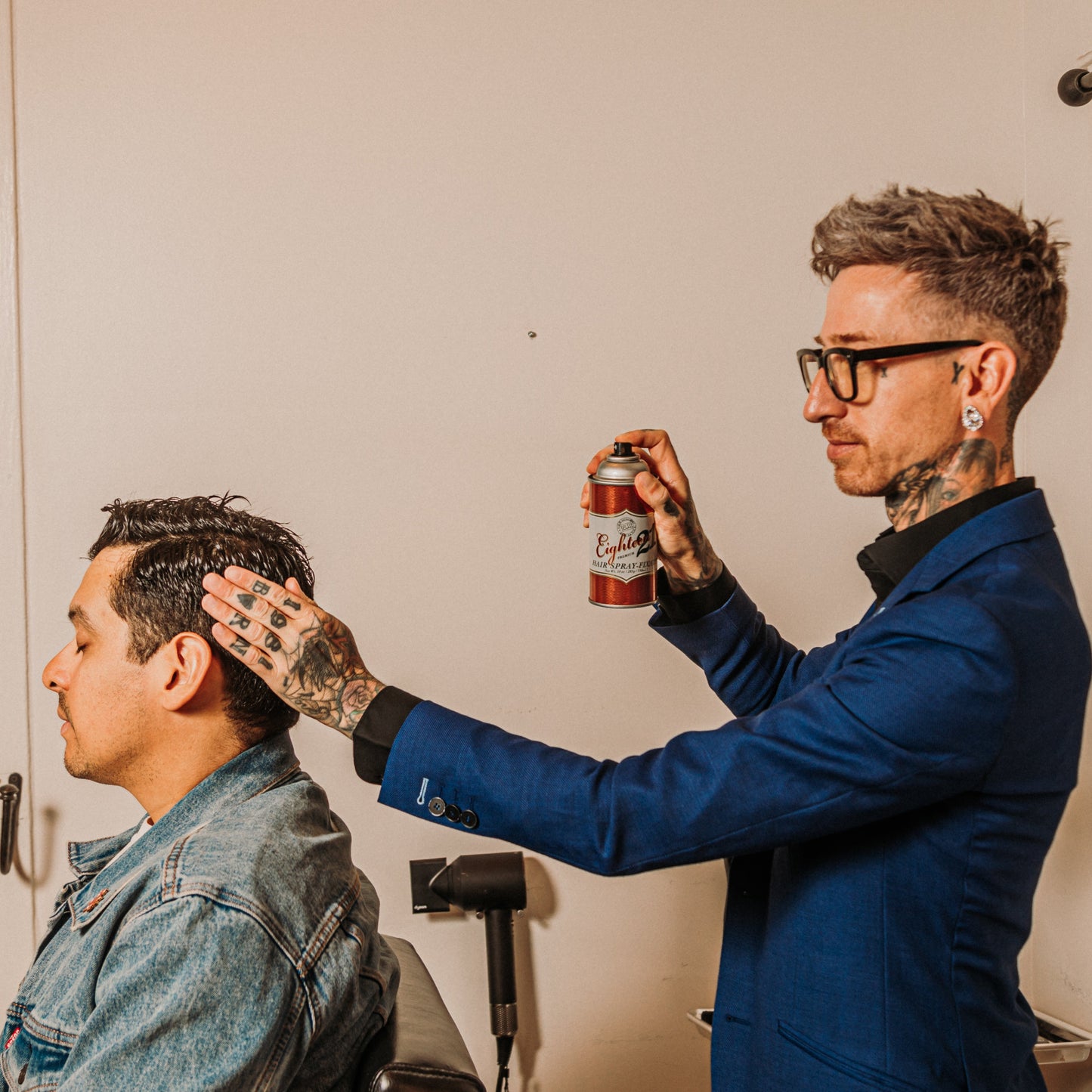 18.21 Man Made Premium Hair Spray — stylist finishing with hair spray, lifestyle shot